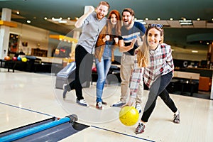 Friends having fun while bowling