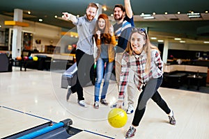 Friends having fun while bowling