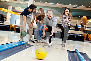 Friends having fun while bowling