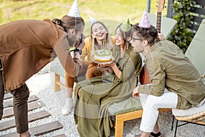 Friends having fun celebrating birthday party outdoors