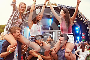 Friends having fun in the crowd at a music festival