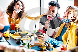 Friends having fun drinking at cocktail bar - Multiracial people talking together at restaurant reopening - New normal life