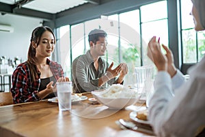 friends having fun eating lunch together at home with traditional food