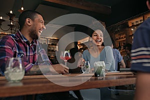 Friends having fun over drinks together in a bar