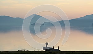 Friends having fun on a pier . lake prespa, macedonia, sunset on a lake,