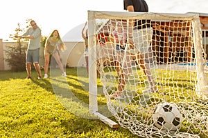 Friends having fun playing football in the backyard