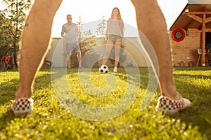 Friends having fun playing football in the backyard