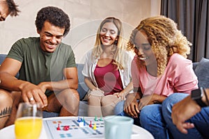 Friends having fun playing ludo