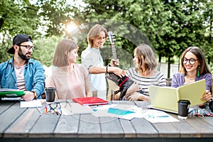 Friends having fun during a study outdoors