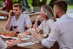 friends having picnic french dinner party outdoor during summer holiday