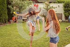 Friends having a squirt guns war