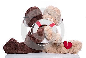 Friends help: teddy bears back to back giving support isolated