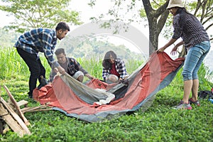 Friends hiker setting up the tent