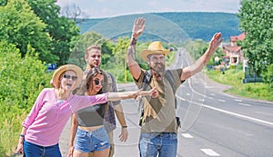 Friends hitchhikers travelling sunny day. Begin great adventure in your life with hitchhiking. Company friends travelers