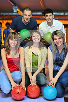 Friends hold ball for bowling