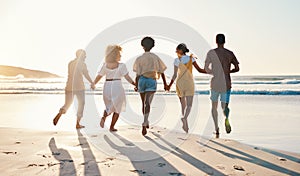 Friends, holding hands and running at sunset on beach in summer, vacation or walking together on holiday break with
