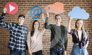 Friends holding up social media and technology concept icons