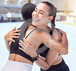 Friends hug and smile for congratulations, running or exercising outdoors on racetrack. Woman, support and winner, happy