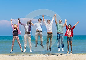 Friends jumping on the beach