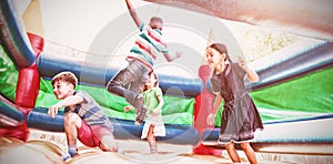 Friends jumping on bouncy castle photo