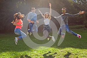 Friends jumping and having fun at sunny day
