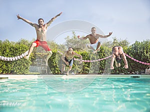 Friends jumping in a swimming pool