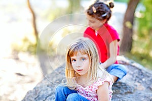 Friends kid girls playing in forest rock