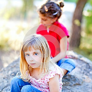 Friends kid girls playing in forest rock