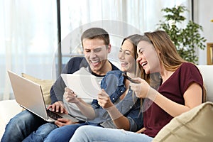 Friends laughing hard watching videos at home