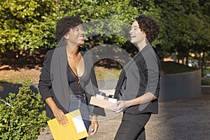 Friends laughing during meeting on the way to work