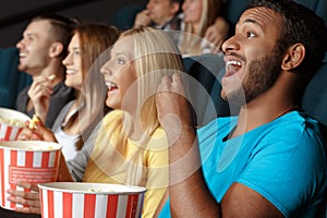 Friends laughing during a movie