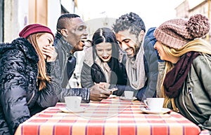 Friends looking at smartphone in a bar