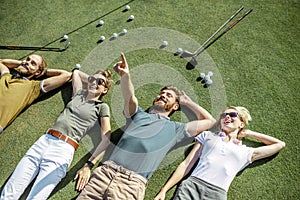 Friends lying on the golf course