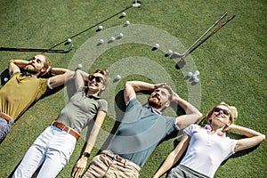 Friends lying on the golf course