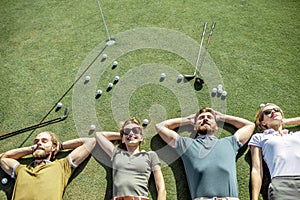 Friends lying on the golf course