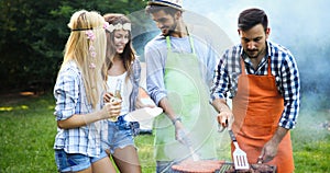 Friends making barbecue and having lunch