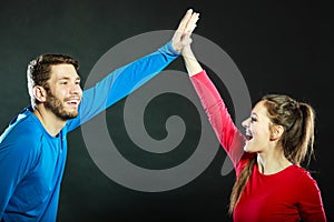 Friends man and woman celebrating giving high five