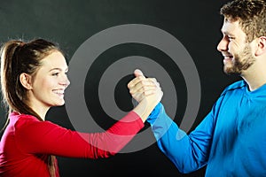 Friends man and woman clasping shaking hands.