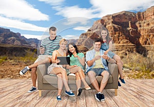 Friends with modern gadgets over grand canyon