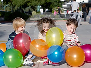 Friends with multi-coloured inflatable spheres