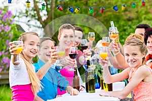 Friends and neighbors toasting on garden party