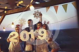 Friends at a New Year`s Eve outdoor pool party