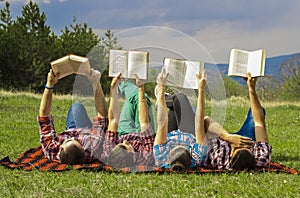 Friends outdoors with book