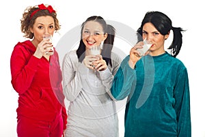 Friends in pajamas drinking milk