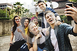 Friends in the park taking a group selfie millennial and youth c