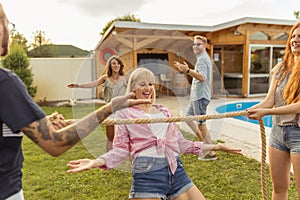 Friends participating in limbo dance contest