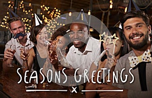 Friends at a party in a bar with Seasons Greetings message