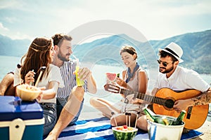 Friends partying on the beach with drinks