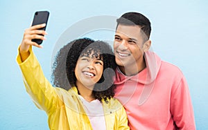 Friends, phone and face with smile for selfie on a blue background for fashion, style or friendship together. Young man