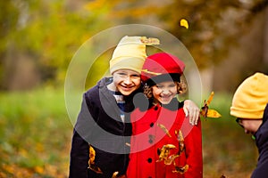 Friends play in a beautiful autumn park together